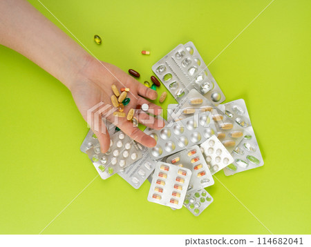 Hand with Color Pill Capsules on Green Background, Overdose Concept, Opioid Problem, Poison, Analgesic 114682041