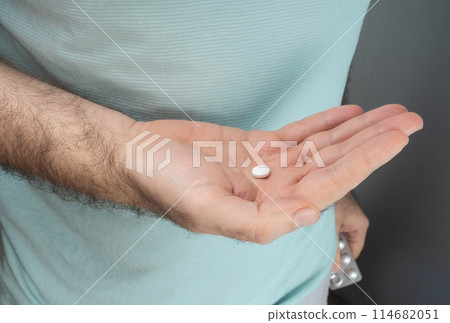 Pill Blister in Hands on Blurred Background Pill Blister in Hands on Blurred Background 114682051
