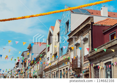 Festive bunting and lanterns decorate a narrow street for summer festival in June San Juan 114682108