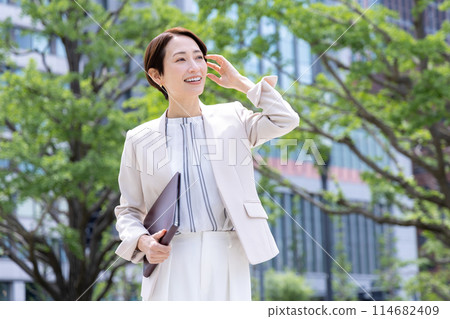 Portrait of a woman holding a business file Portrait of a woman holding a business file 114682409