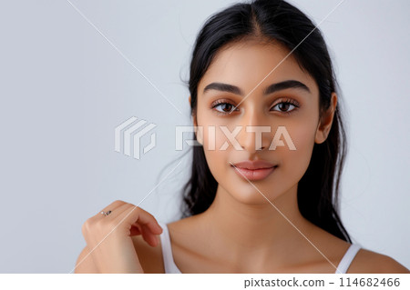 Portrait of a young Indian woman with striking features and subtle makeup 114682466
