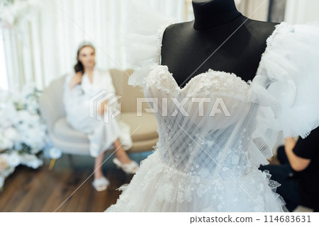White wedding dress on a black dummy before the bride puts it on 114683631