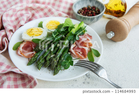 Fresh Asparagus and Prosciutto Salad Served With Boiled Eggs and Microgreens Fresh Asparagus and Prosciutto Salad Served With Boiled Eggs and Microgreens 114684993