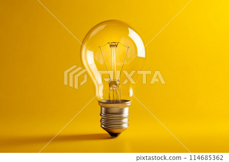 Bright yellow light bulb with metal base and six sides 114685362