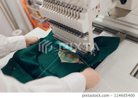 Embroidery machine needle in Textile Industry at Garment Manufacturers, Embroidery T-shirt in progress, Needle with thread 114685400