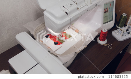 Embroidery machine needle in Textile Industry at Garment Manufacturers, Embroidery T-shirt in progress, Needle with thread Embroidery machine needle in Textile Industry at Garment Manufacturers, Embroidery T-shirt in progress, Needle with thread 114685525