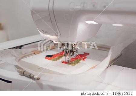 Embroidery machine needle in Textile Industry at Garment Manufacturers, Embroidery T-shirt in progress, Needle with thread Embroidery machine needle in Textile Industry at Garment Manufacturers, Embroidery T-shirt in progress, Needle with thread 114685532