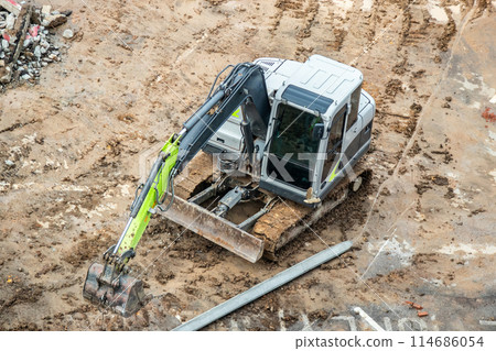 Backhoe excavator at construction site 114686054