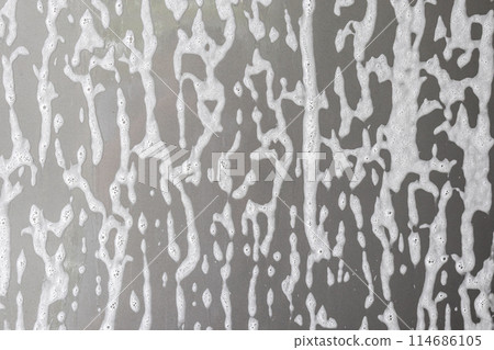 car cleaning and washing with foam soap on the gray car background 114686105