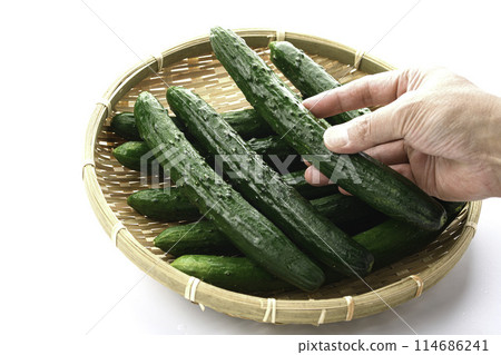 Cucumber on a colander (white background) Cucumber on a colander (white background) 114686241
