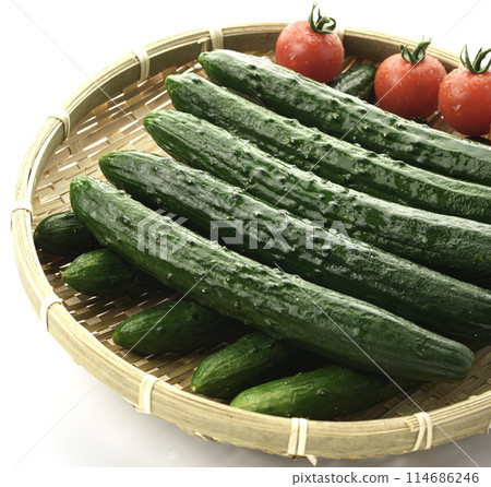 Cucumber and tomato on a colander (white background) Cucumber and tomato on a colander (white background) 114686246