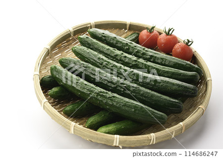 Cucumber and tomato on a colander (white background) Cucumber and tomato on a colander (white background) 114686247