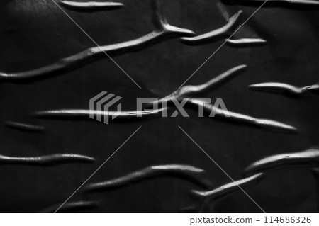 black crumpled and creased plastic poster texture background black crumpled and creased plastic poster texture background 114686326