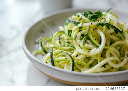 Light zucchini noodles with fresh herbs, served in a stylish ceramic bowl. Perfect healthy meal 114687537