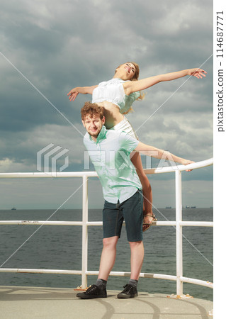couple in love having fun on sea pier 114687771