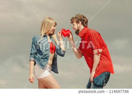 couple in love holds red heart outdoor 114687786