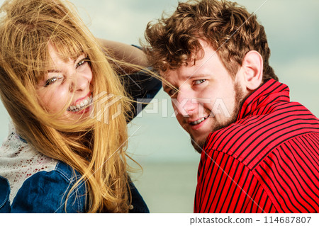 Closeop couple relaxing on sea shore Closeop couple relaxing on sea shore 114687807