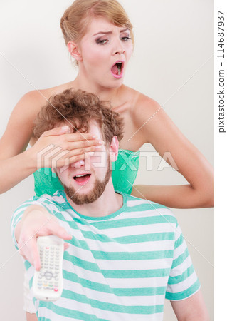 Funny couple with TV remote 114687937