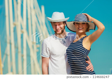 Tourist couple in marina against yachts in port 114688247