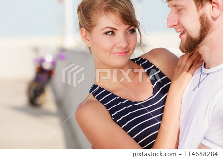 Tourist couple in marina with motorcycle Tourist couple in marina with motorcycle 114688284