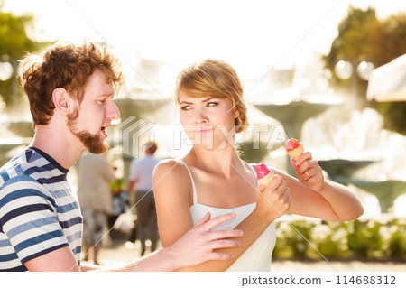 young couple eating ice cream outdoor young couple eating ice cream outdoor 114688312