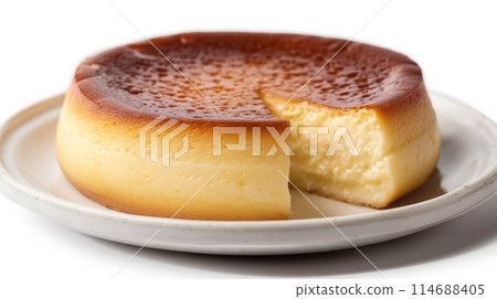 A golden brown Basque cheesecake with a slice removed, on a white plate against a white background A golden brown Basque cheesecake with a slice removed, on a white plate against a white background 114688405