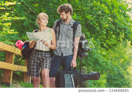 Hiking backpacking couple reading map on trip. 114688685