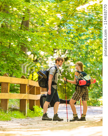 couple backpacker hiking in forest pathway 114688770