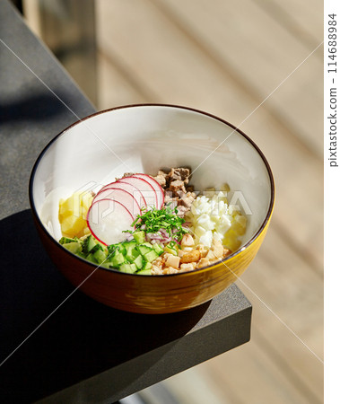 Sunny bowl with diced ingredients for refreshing okroshka Sunny bowl with diced ingredients for refreshing okroshka 114688984