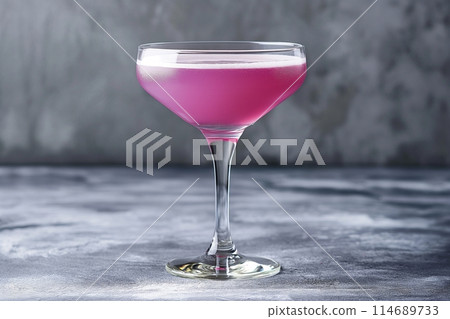 Elegant Aviation cocktail in a classic coupe glass on a textured grey background 114689733