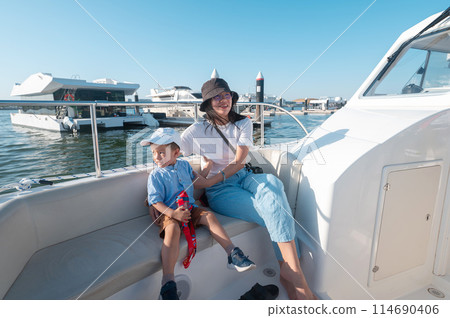 Family enjoying a boat ride at Al Raha 114690406