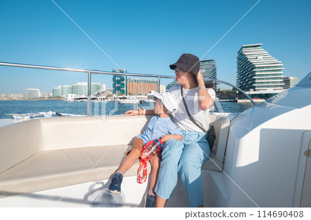 Family enjoying a boat ride at Al Raha 114690408