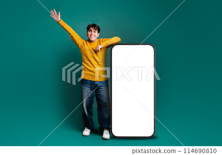 man with animated pose celebrating happily, leaning on a giant cell 114690810