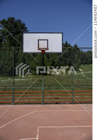 basketball hoop in an outdoor court basketball hoop in an outdoor court 114692487