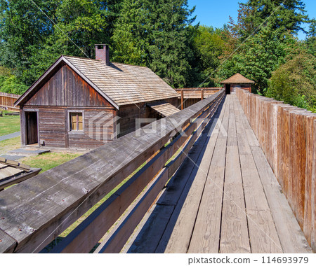 An old wooden fortress with a residential house in the inner yard An old wooden fortress with a residential house in the inner yard 114693979