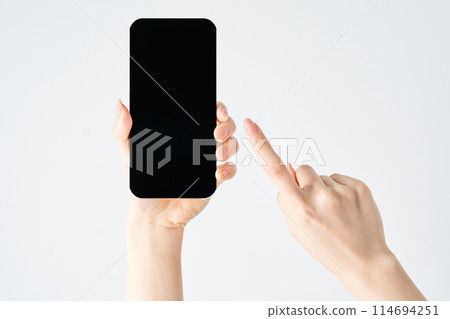 Hand of a woman who operates a smartphone Hand of a woman who operates a smartphone 114694251