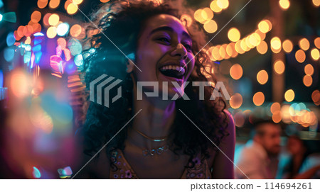 model laughing with a drink in their hand, the festival lights twinkling in their eyes 114694261