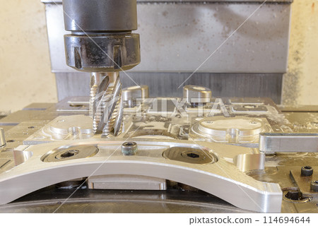 The CNC milling machine cutting  aluminum automotive part by rough cutter. 114694644