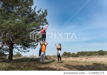 Tourists catching cellular network signal in forest. Tourists catching cellular network signal in forest. 114695175
