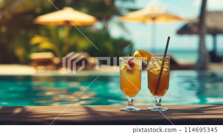 Cocktail glasses by the pool in summer, beachside at resort 114695345