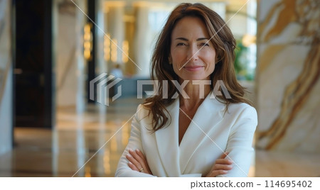 Woman in White Suit Standing in Lobby Woman in White Suit Standing in Lobby 114695402