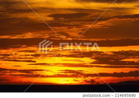 Fiery red sunset over the sea. A terrible bloody evening Fiery red sunset over the sea. A terrible bloody evening 114695690