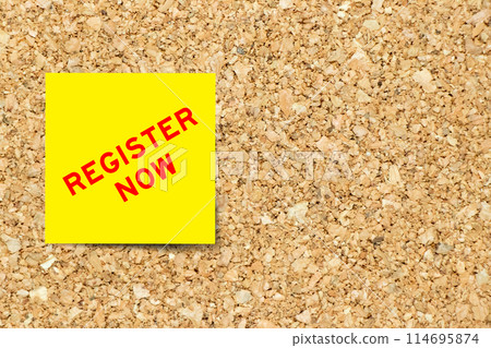 Yellow note paper with word register now on cork board background with copy space Yellow note paper with word register now on cork board background with copy space 114695874