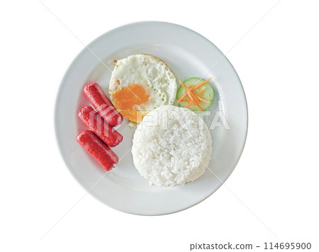 Breakfast on a white plate including sausages, rice, fried egg, fresh vegetables isolated on peach background 114695900