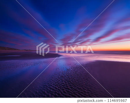 Seascape during sunrise. Long exposure. Bright clouds on the sky.  114695987