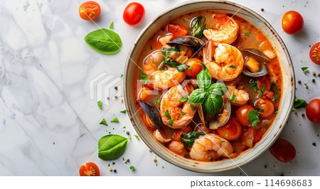 Bowl of Shrimp and Tomato Soup With Basil 114698683
