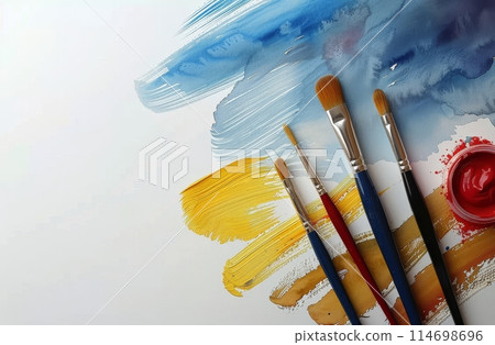 Watercolor Paints and Brushes on a White Surface 114698696