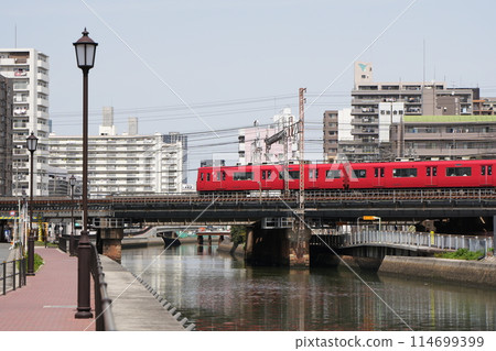 A red train crossing the Horikawa River 114699399