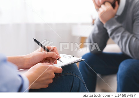 Doctors notes. Pen in hands of smart professional psychologist, being ready to take notes about patient's mental health, free space Doctors notes. Pen in hands of smart professional psychologist, being ready to take notes about patient's mental health, free space 114699487