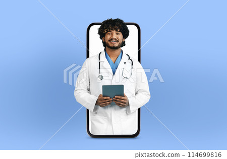 Smiling young indian man doctor with a tablet, presented within a smartphone frame, illustrating a user-friendly telehealth app interface 114699816